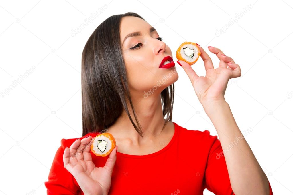Young woman holding sushi, isolated on white