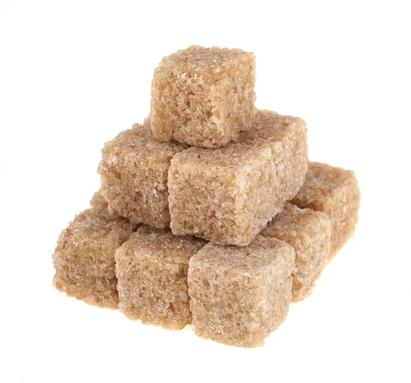 Lump brown cane sugar cubes isolated on white background — Stock fotografie