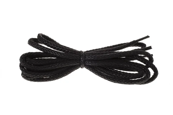 Cordones negros para zapatos sobre fondo blanco — Foto de Stock