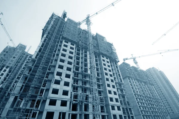 Construction site with buildings and cranes — Stock Photo, Image