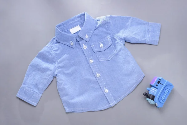 Single blue infant long sleeve shirt and toy — Stock Photo, Image