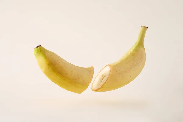 Idea Splitting Two Levitation Cut Banana Levitates Freely Creamy Background — Stockfoto