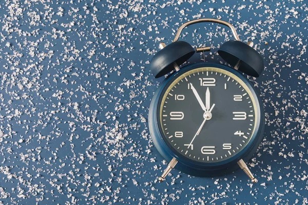 Reloj Despertador Sobre Fondo Azul Frío Con Nieve Dispersa Conceptual —  Fotos de Stock