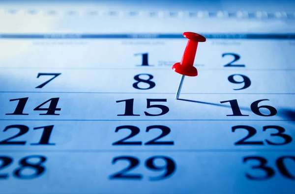 Red pin marking the 15th on a calendar — Stock Photo, Image