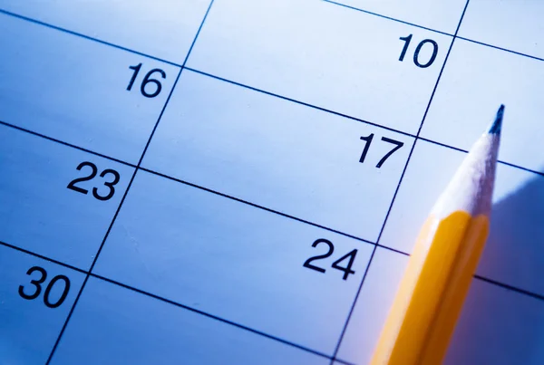Pencil lying on a calendar — Stock Photo, Image