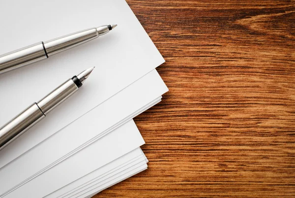 Pens and Sheets on Wooden Table with Copy Space — Stock Photo, Image