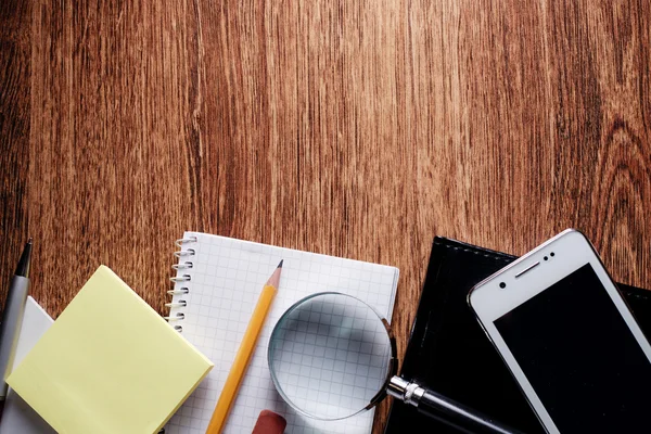 Office Supplies with Magnifying Glass on Table — Stock Photo, Image