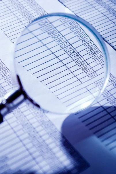 Conceptual Magnifying Glass on Invoice Reports — Stock Photo, Image