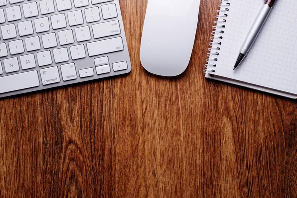 Pen och anteckningar med tangentbordet och musen på bord — Stockfoto
