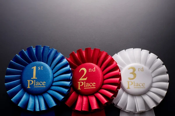 Three places pleated ribbon rosettes — Stock Photo, Image