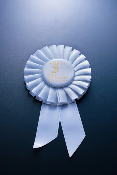 The prize for third place on a blue background — Stock Photo, Image