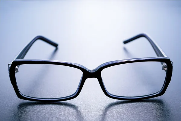 Horn-rimmed glasses on blue background