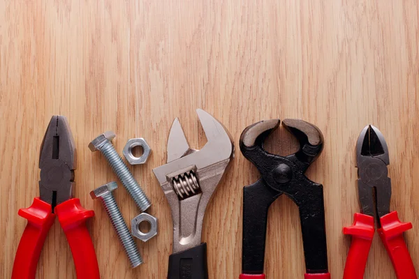 Bolts and nuts with a set of plumbing tools — Stock Photo, Image