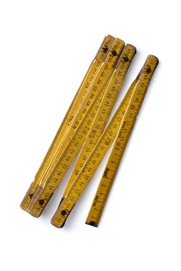 Yellow wooden folding ruler on a white background clipart