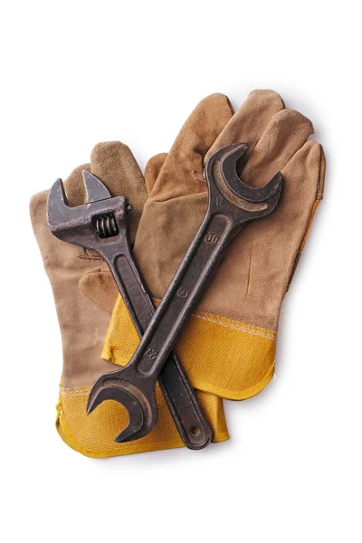 Due chiavi su guanti protettivi su fondo bianco — Foto Stock