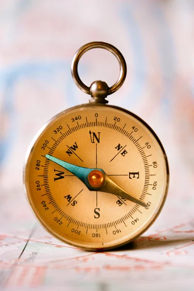 Compass Instrument Standing on Top of Map — Stock Photo, Image