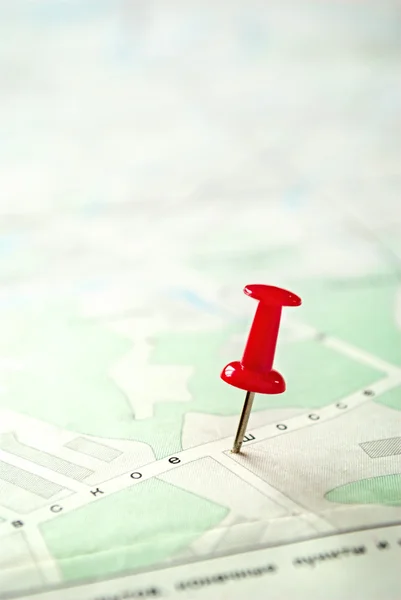 Close up Red Pin Marking on a Green White Map Stock Photo