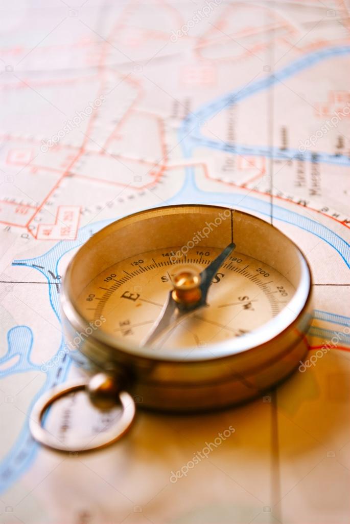 Vintage Compass for Direction Lying on a Map