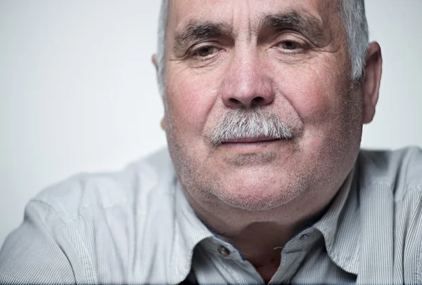 Close-up portrait of a Caucasian senior man with mustache — Stock Photo, Image