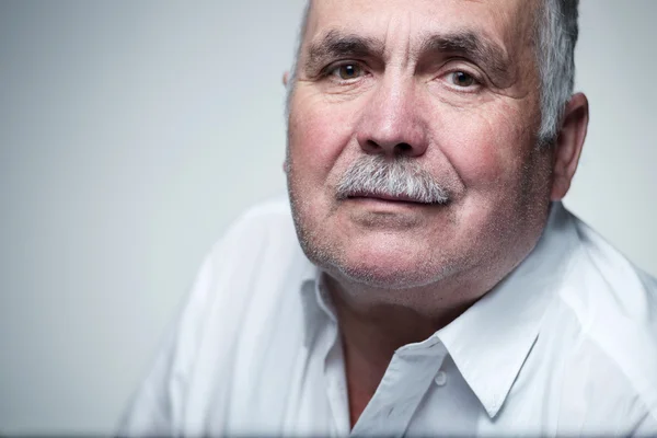 Close-up portrait of a Caucasian senior man with mustache — Stock Photo, Image