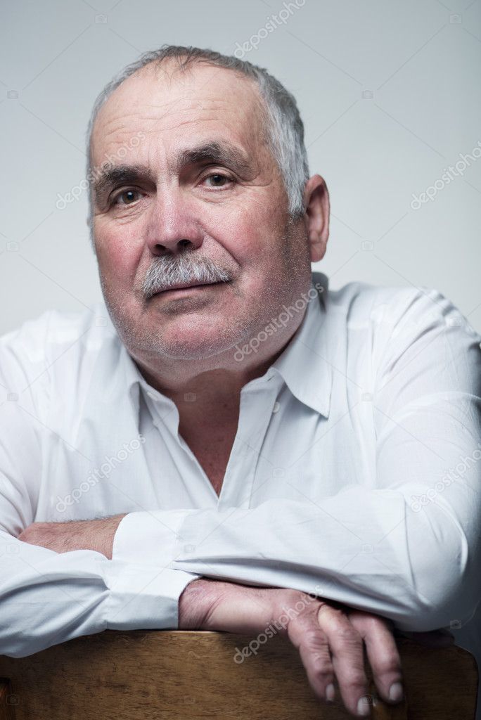 Close-up portrait of a Caucasian senior man with mustache