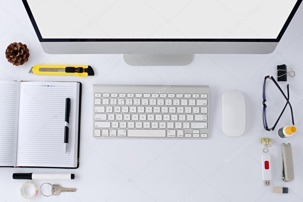 The white office table with stationery accessories, keyboard,computer mouse.