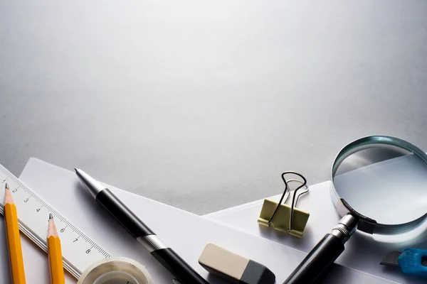 Office Supplies Scattered on Grey Desk — Stock Photo, Image