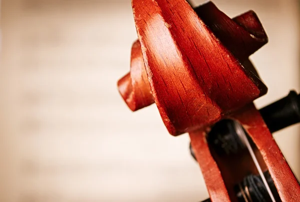 Close Up of Violin Scroll in front of Sheet Music — ストック写真