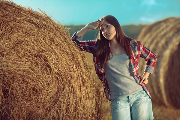 Girl next to haystack — Stock Photo, Image