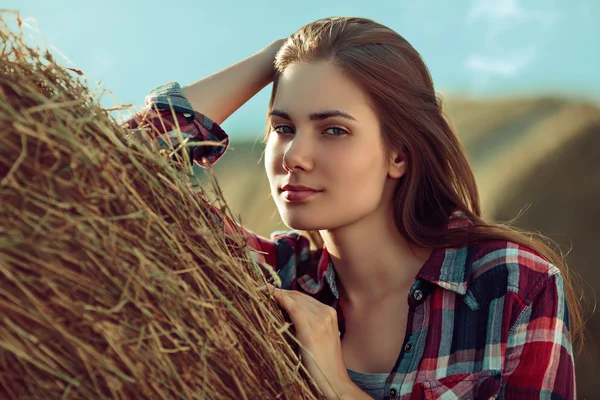 Girl next to haystack — Stock Photo, Image