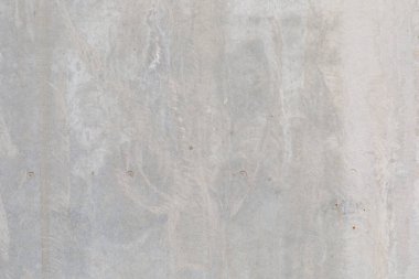 Açık gri beton duvar yüzeyinin tam çerçeve yakın çekimi hafif pürüzsüz mala, kıvrımlar..