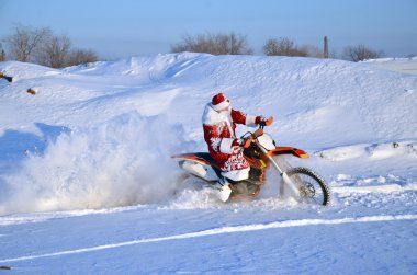 Santa Claus astride on the motocross bike clipart