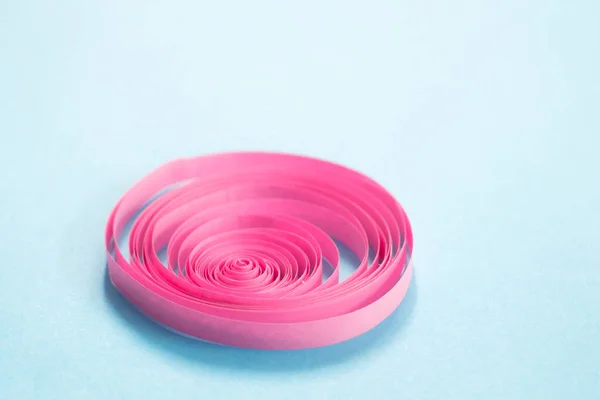 Swirling Pink Strip Paper Blue Background — Stock Photo, Image