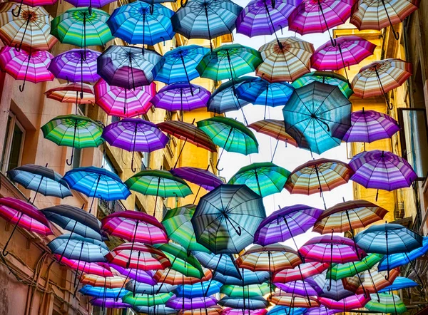 Colorful umbrellas floating above the street — Stock Image Colorful Umbrellas Floating Street Royalty Free Stock Photos