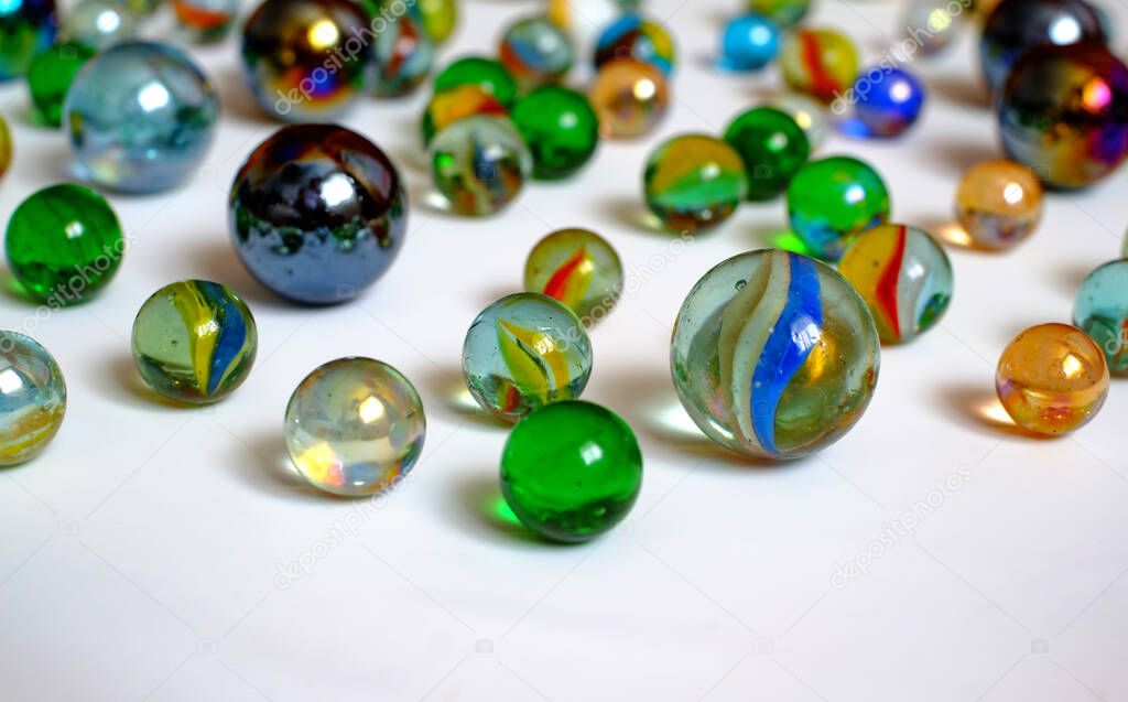 glass balls of various colors and sizes on white background