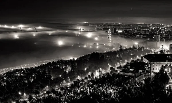 スペイン クレーンと観覧車でマラガ市内の霧の夜の景色 — ストック写真