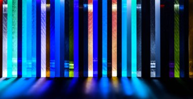 light through Stack of different colours Cast Acrylic Sheet on black background clipart
