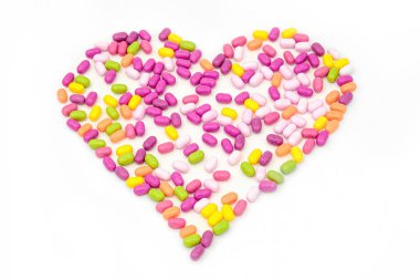 Bir grup ilaç ya da ilaç, beyaza izole edilmiş kalp şeklinde düzenlenir.