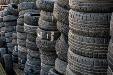 Sibiu, Romania - January 24, 2019. Used tire stacks in Workshop vulcanization yard in the city clipart