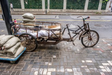 Şangay, Çin - 28 Nisan 2025. Çin Üç Tekerlekli Teslimat Bisikleti. Pedallı ve elektrikli motorlu teslimatlarda kullanılan eski bir Çin kargo üç tekerlekli bisikleti.