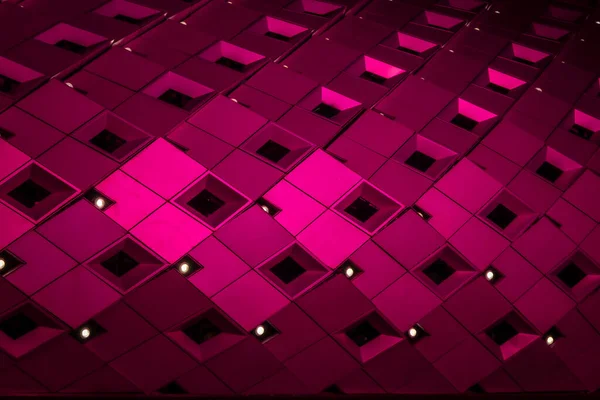 Geometrik, metalik yüzey kare karolardan oluşan bir şebeke deseni içeriyor. Fayanslar dinamik, soyut ve görsel olarak çarpıcı modern mimari bir cephe oluşturan canlı ışıklandırmayla aydınlatılıyor.