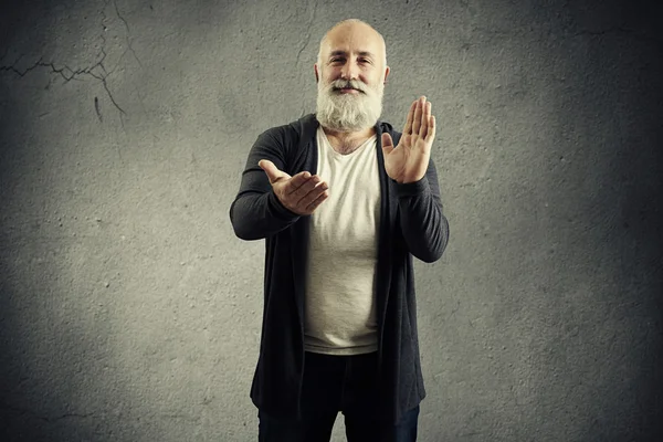 smiley bearded man clapping and looking at camera