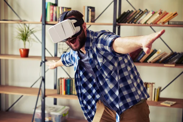 Man flying in virtual reality using modern VR headset glasses — Stock Photo, Image
