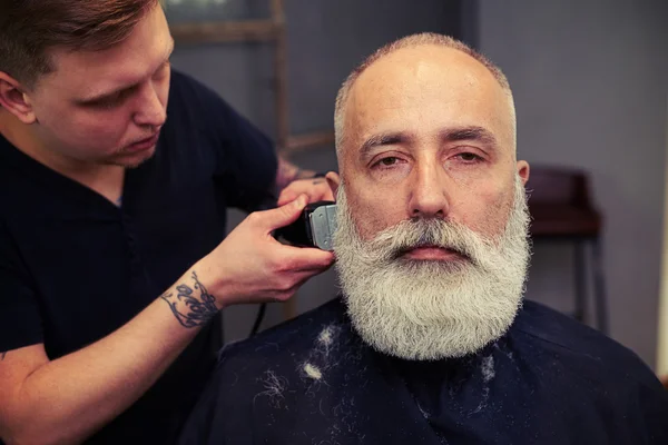 Portrait of serious attractive senior man in the barbershop — Stock Photo, Image