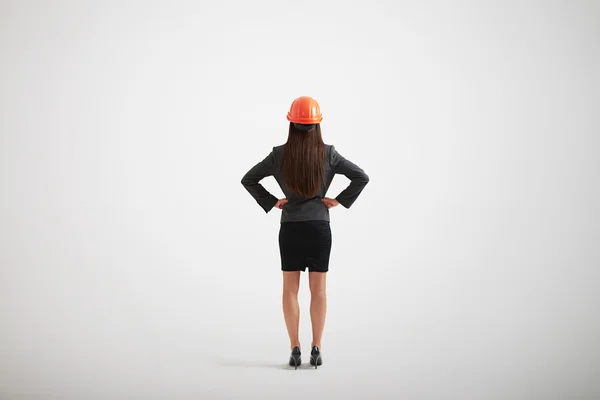 Femme en tenue formelle et casque de construction avec ses bras akimb — Photo