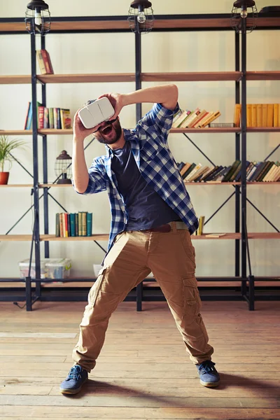 Young man laughing wearing hi-tech VR headset — Stock Photo, Image