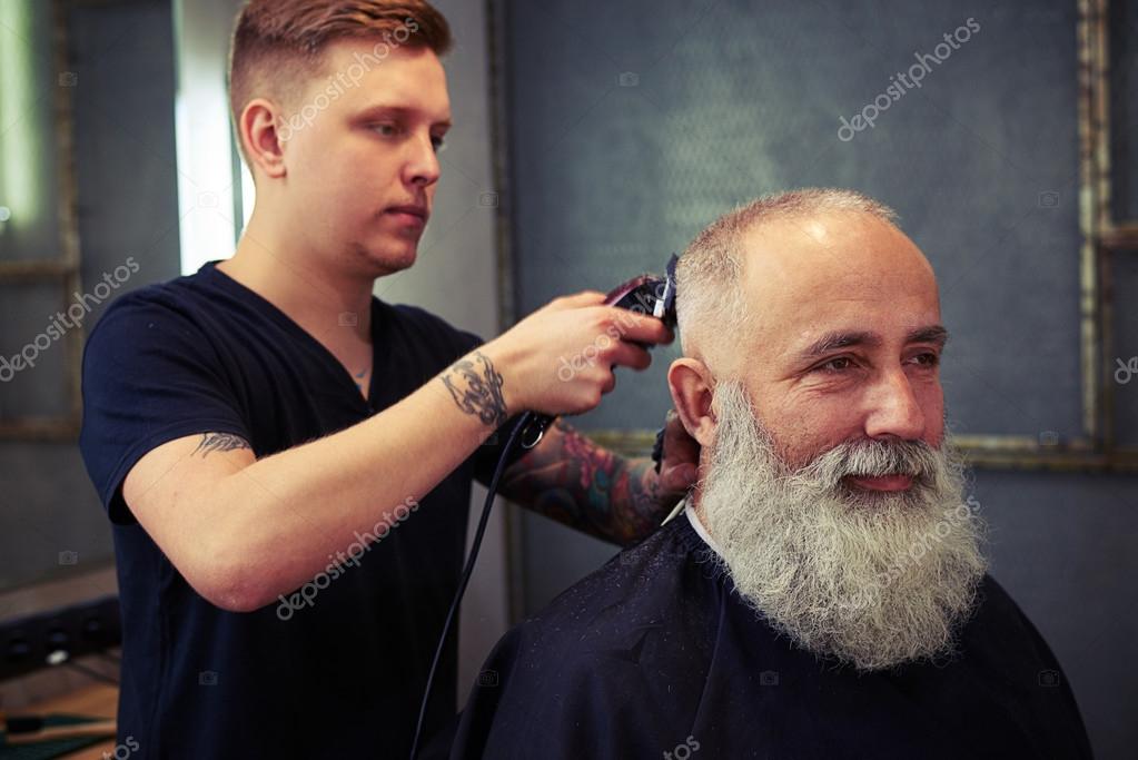 Barber making hear to handsome bearded man Stock Photo by ©konstantynov 105844850 Barber making hear to handsome bearded man Stock Photo by ©konstantynov 105844850