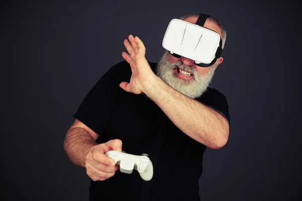 Senior man protect his face playing in virtual reality — 스톡 사진