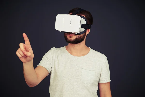 Man touch something wearing hi-tech VR headset — Stock Photo, Image