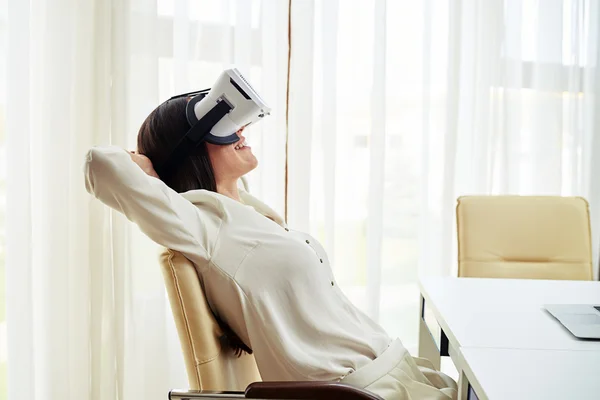 Relaxed young woman in virtual reality glasses in close-up — Stock Photo, Image